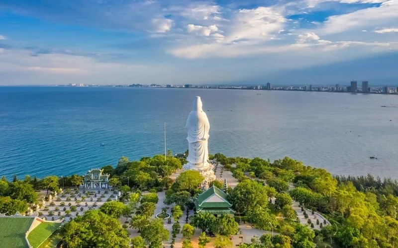 Aerial view of the tall white Lady Buddha statue at Linh Ung Pagoda overlooking Da Nang's coastline. Aerial view of the tall white Lady Buddha statue at Linh Ung Pagoda overlooking Da Nang's coastline.