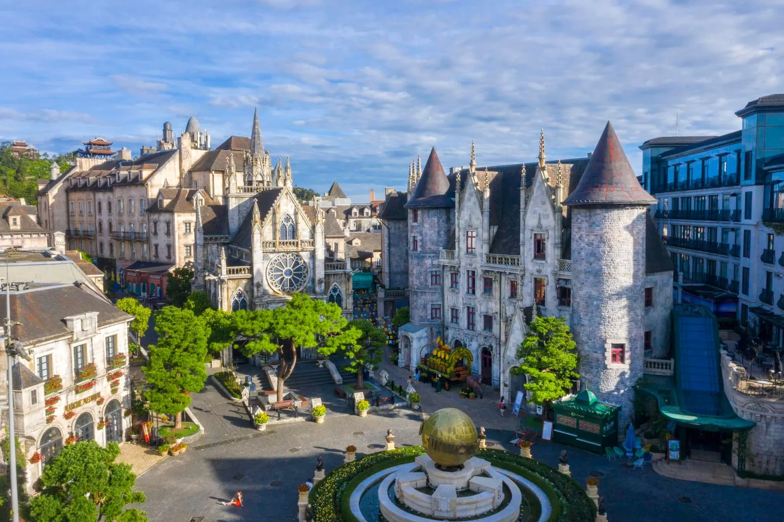 French-style castle towers and a Gothic cathedral rise above a plaza at Ba Na Hills. French-style castle towers and a Gothic cathedral rise above a plaza at Ba Na Hills.