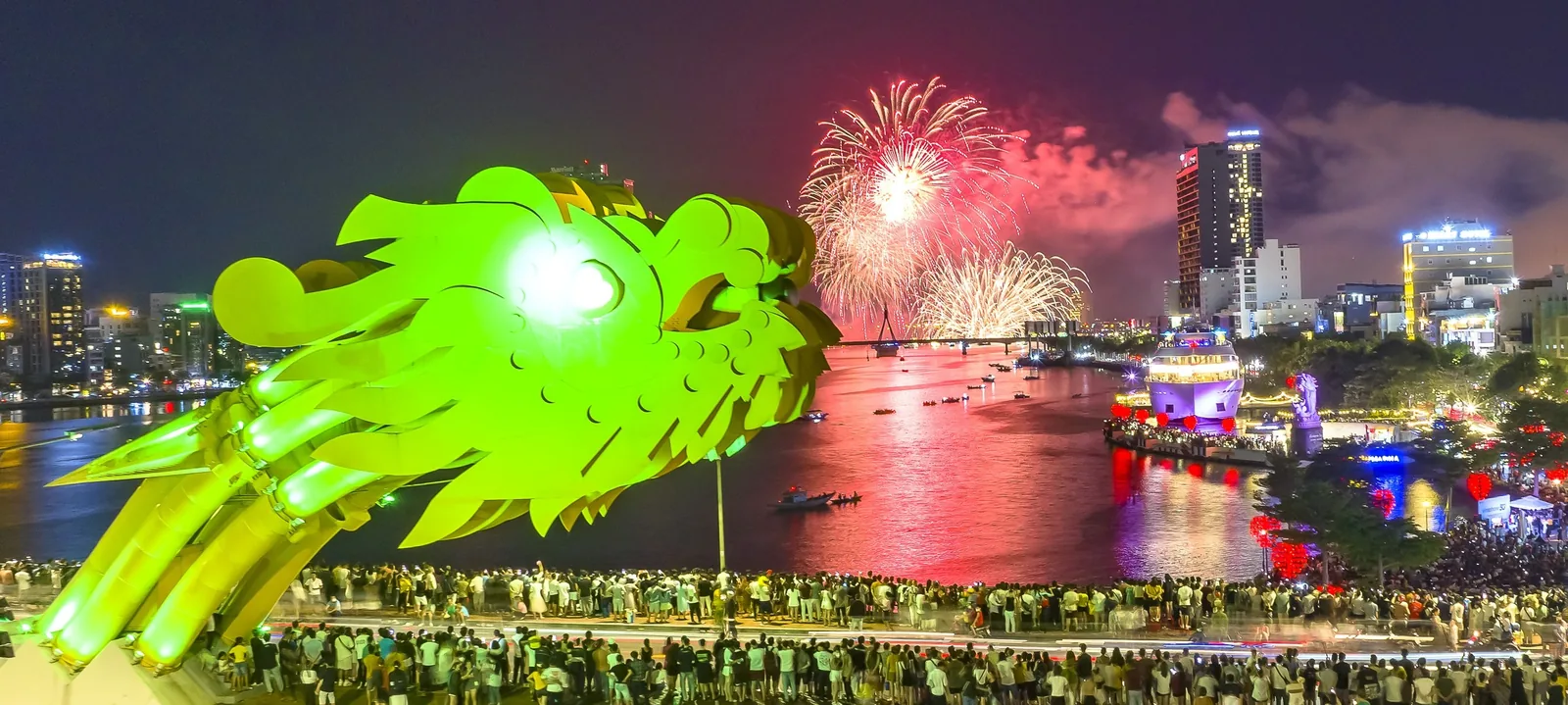 Fireworks light up the sky over the Han River beside the glowing Dragon Bridge in Da Nang. Fireworks light up the sky over the Han River beside the glowing Dragon Bridge in Da Nang.