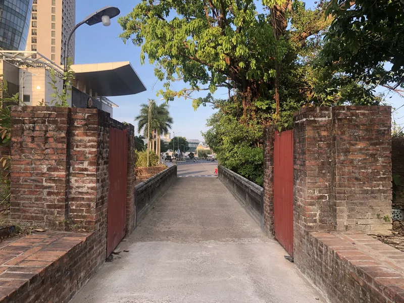 An old brick gate opens onto a footbridge leading toward the city near Dien Hai Citadel in Da Nang. An old brick gate opens onto a footbridge leading toward the city near Dien Hai Citadel in Da Nang.